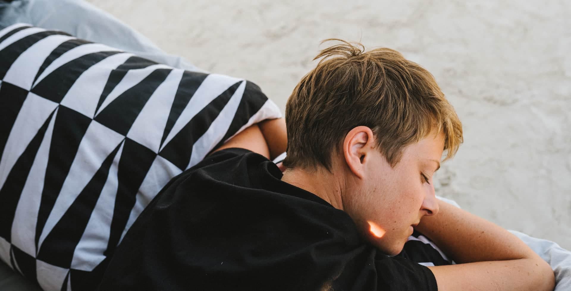 Pojke sover i säng.